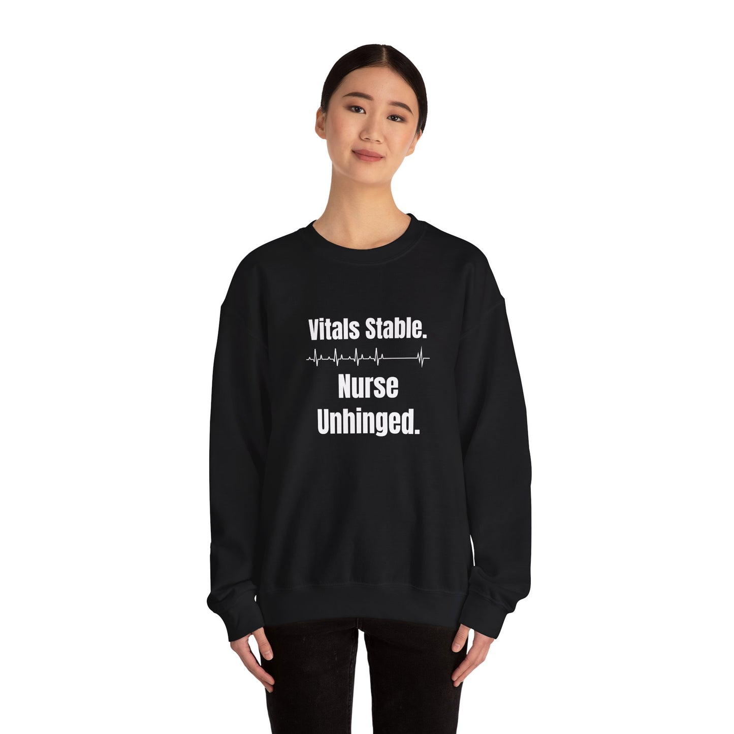 Funny black nurse sweatshirt with quote “Vitals Stable. Nurse Unhinged,” worn by visibly exhausted RN mid-shift meltdown