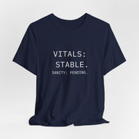 “Vitals Stable. Sanity Pending.” nurse shirt in navy blue, flat lay style, bold text and classic clinical sarcasm