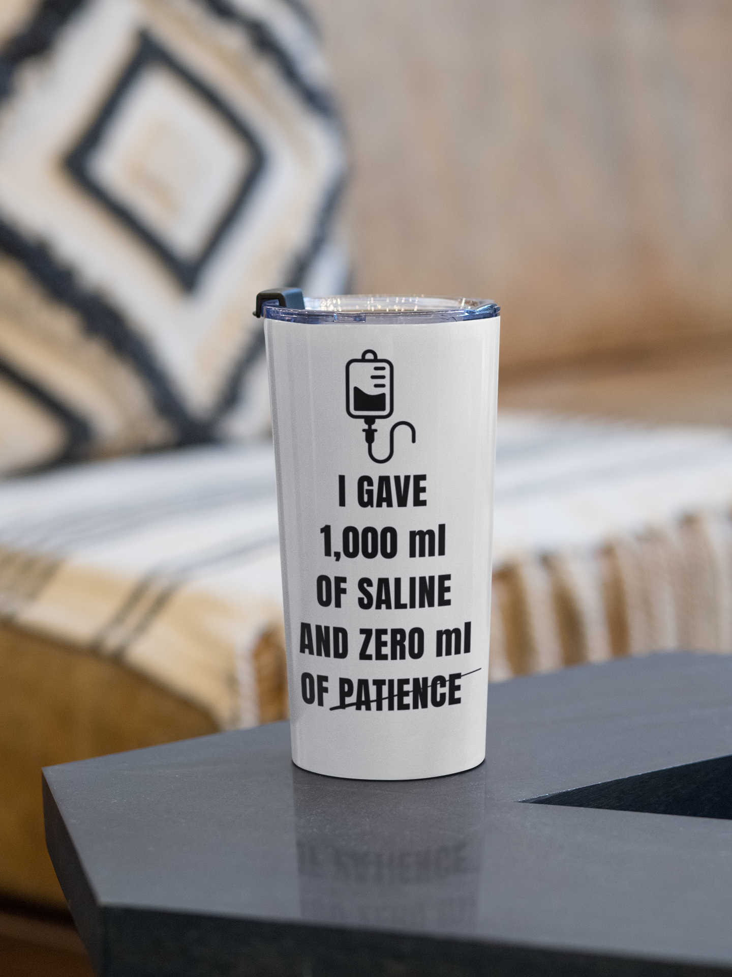 “1,000mL Saline” tumbler resting beside cozy bedding and a notebook, giving off a relaxed post-shift vibe.