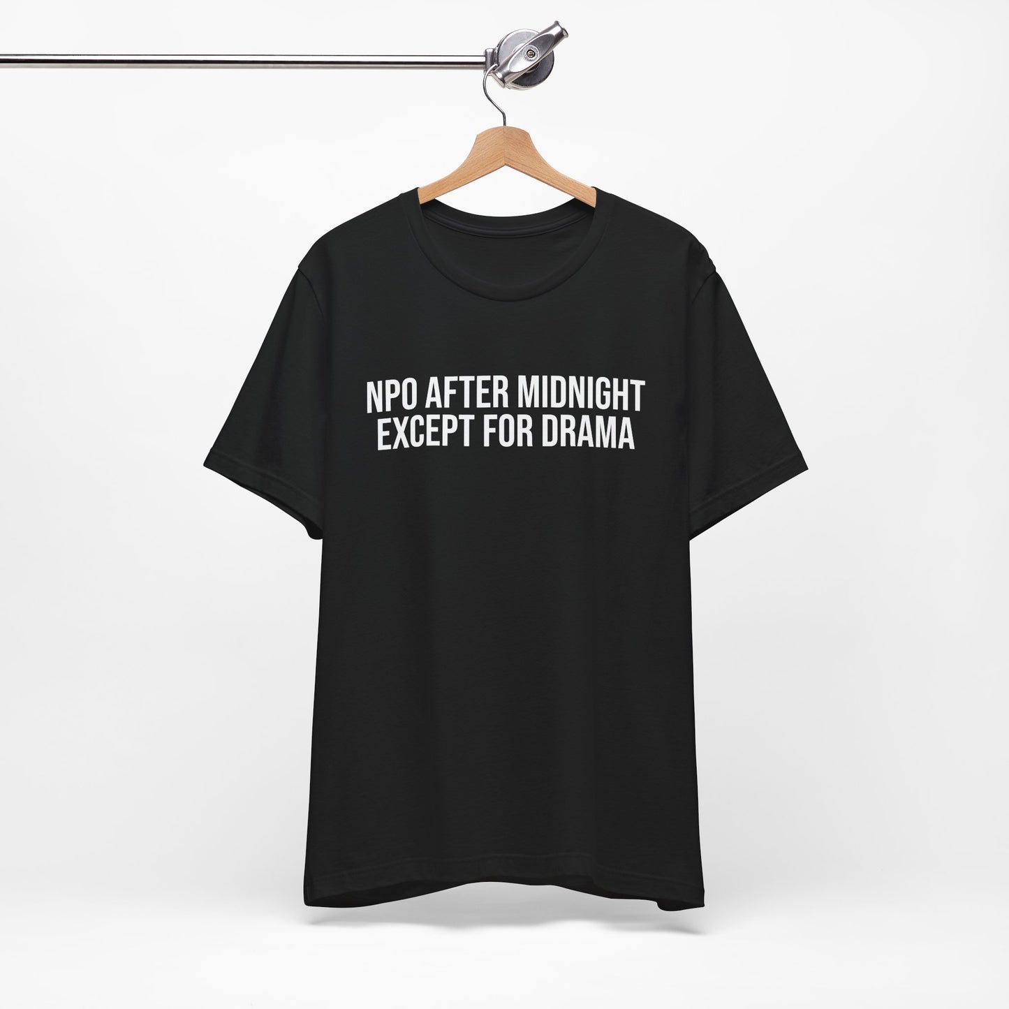 Flatlay of black unisex t-shirt with bold print: “NPO AFTER MIDNIGHT, EXCEPT FOR DRAMA.”