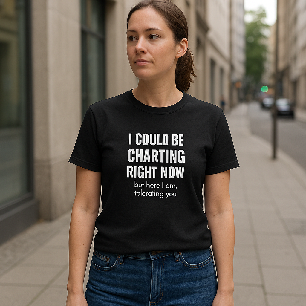 Female nurse walking outdoors in a black “I Could Be Charting Right Now” shirt and jeans.