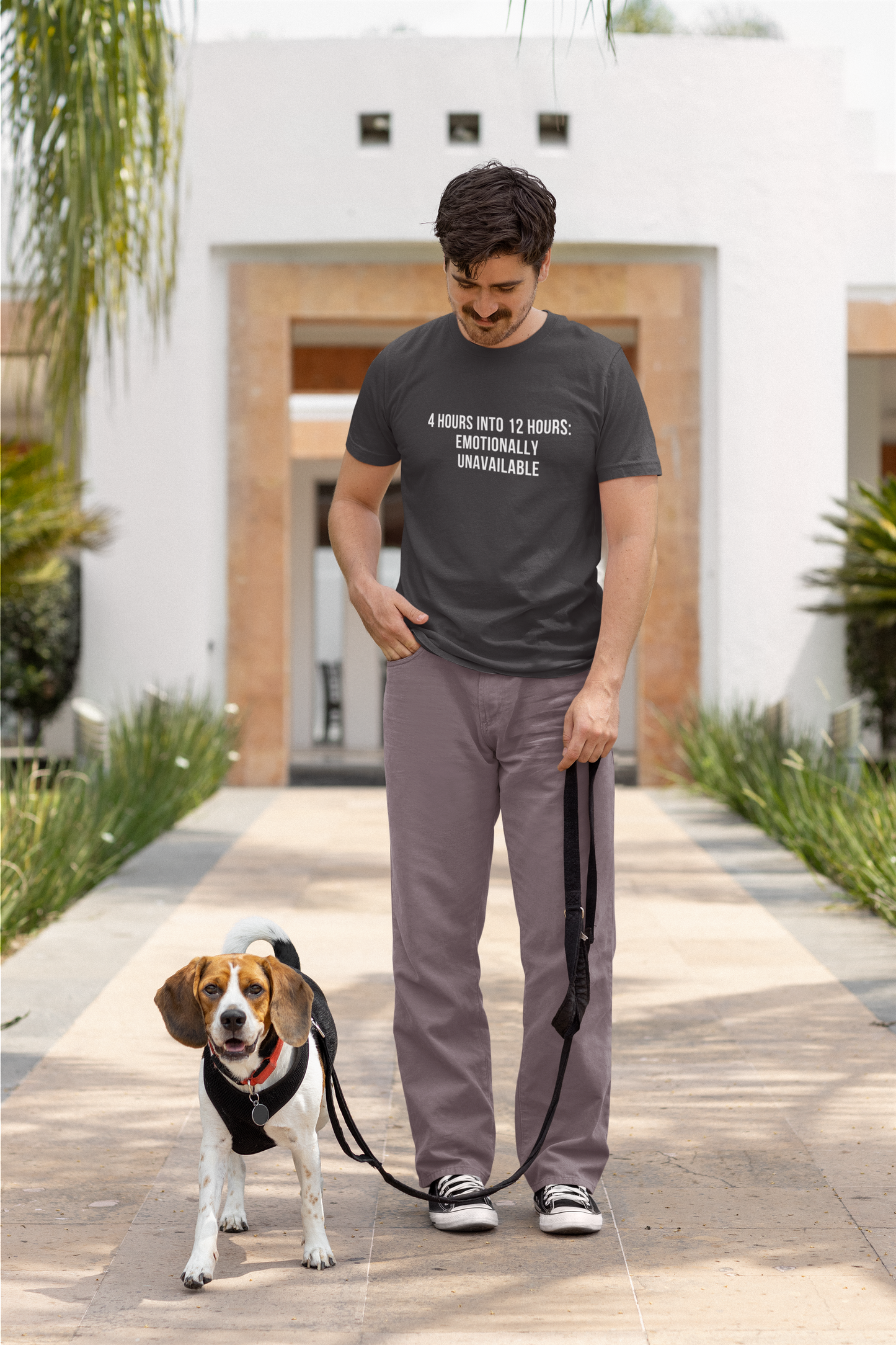 Nurse on casual walk with dog, wearing “Emotionally Unavailable” nurse tee and joggers.