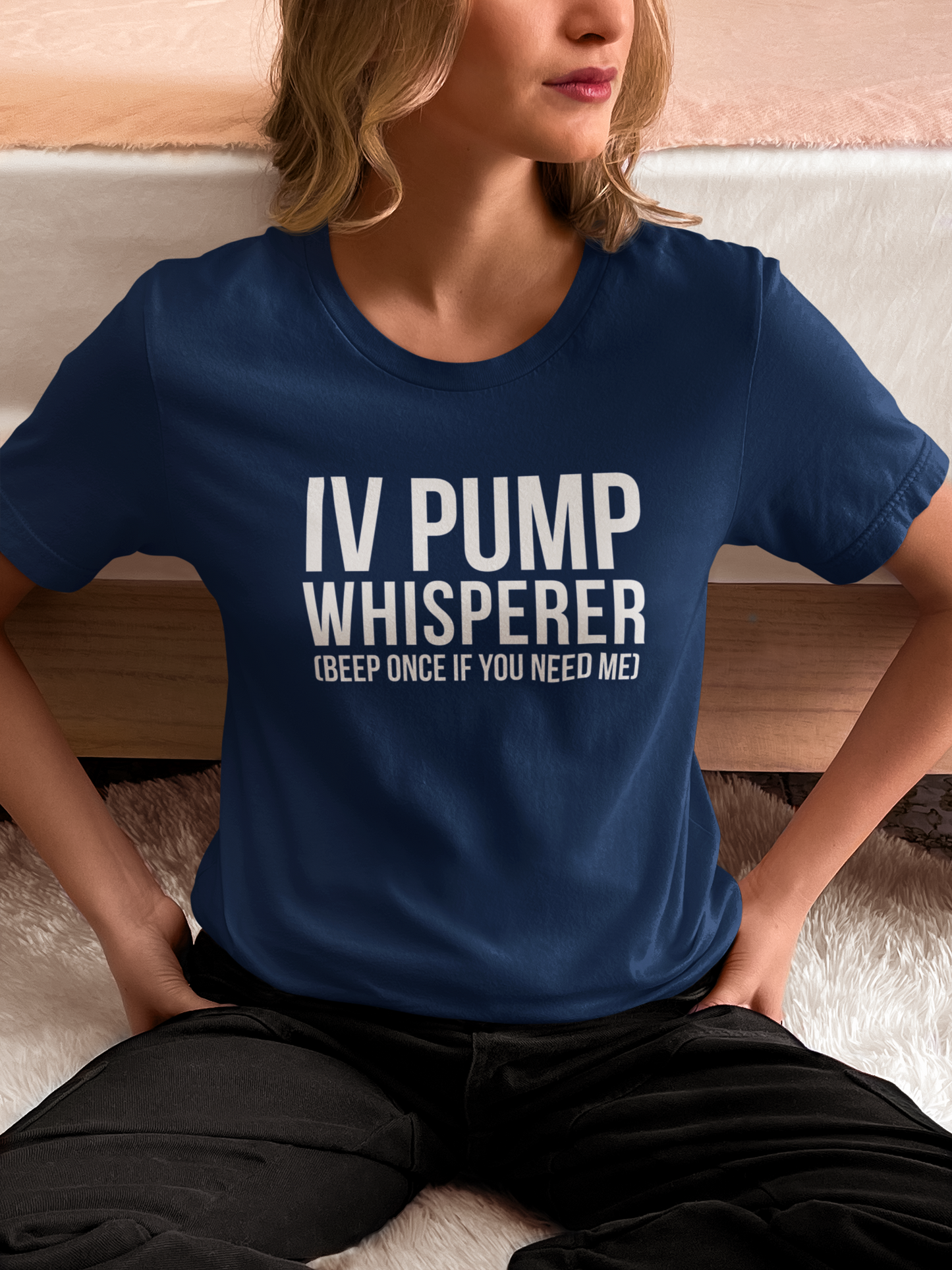 Nurse sitting relaxed in scrubs with sarcastic IV pump shirt.