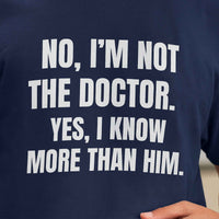 Close-up of shirt print: No, I’m Not The Doctor. Yes, I Know More Than Him, bold white text on navy fabric.