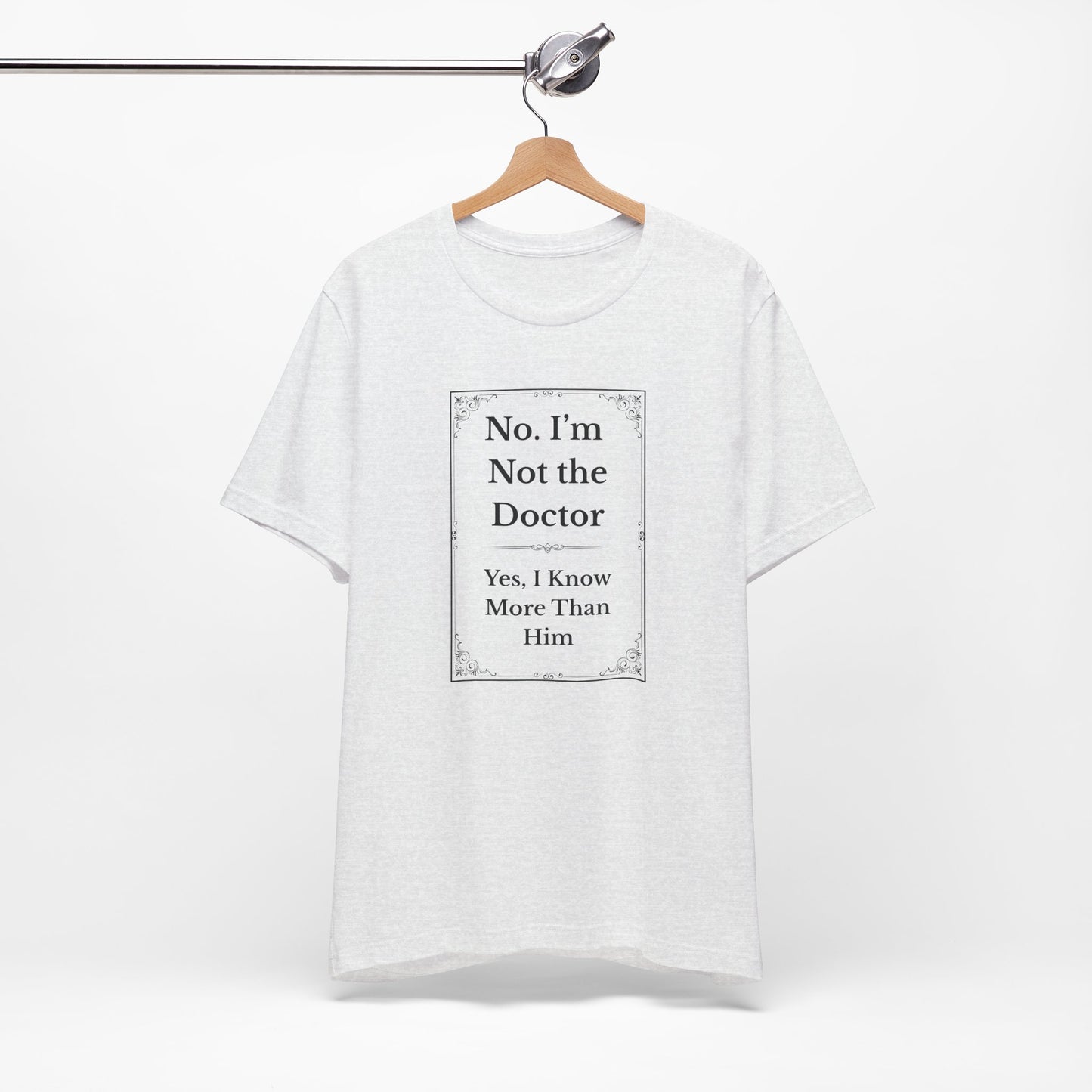 White unisex RN shirt hanging with sarcastic "Not the Doctor, Just Smarter" printed on front.