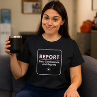 Female nurse in scrubs smiling, wearing "REPORT: Lies, Confessions, and Regrets" shirt, hospital hallway.
