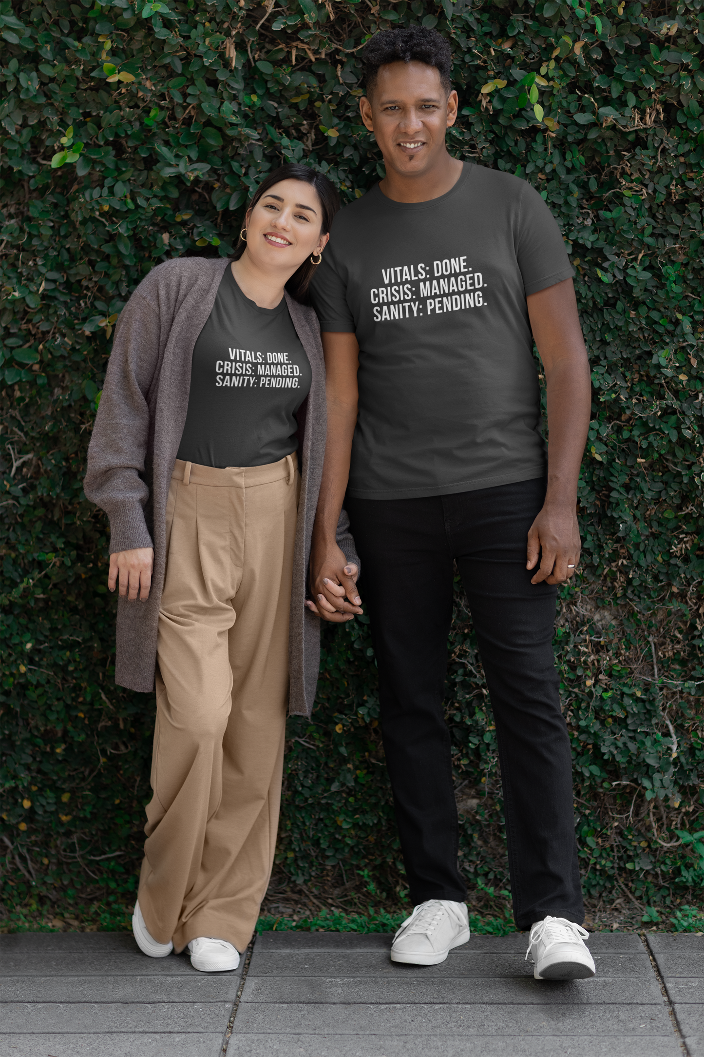 Matching nurse couple wearing the burnout shirts on a casual outdoor walk.