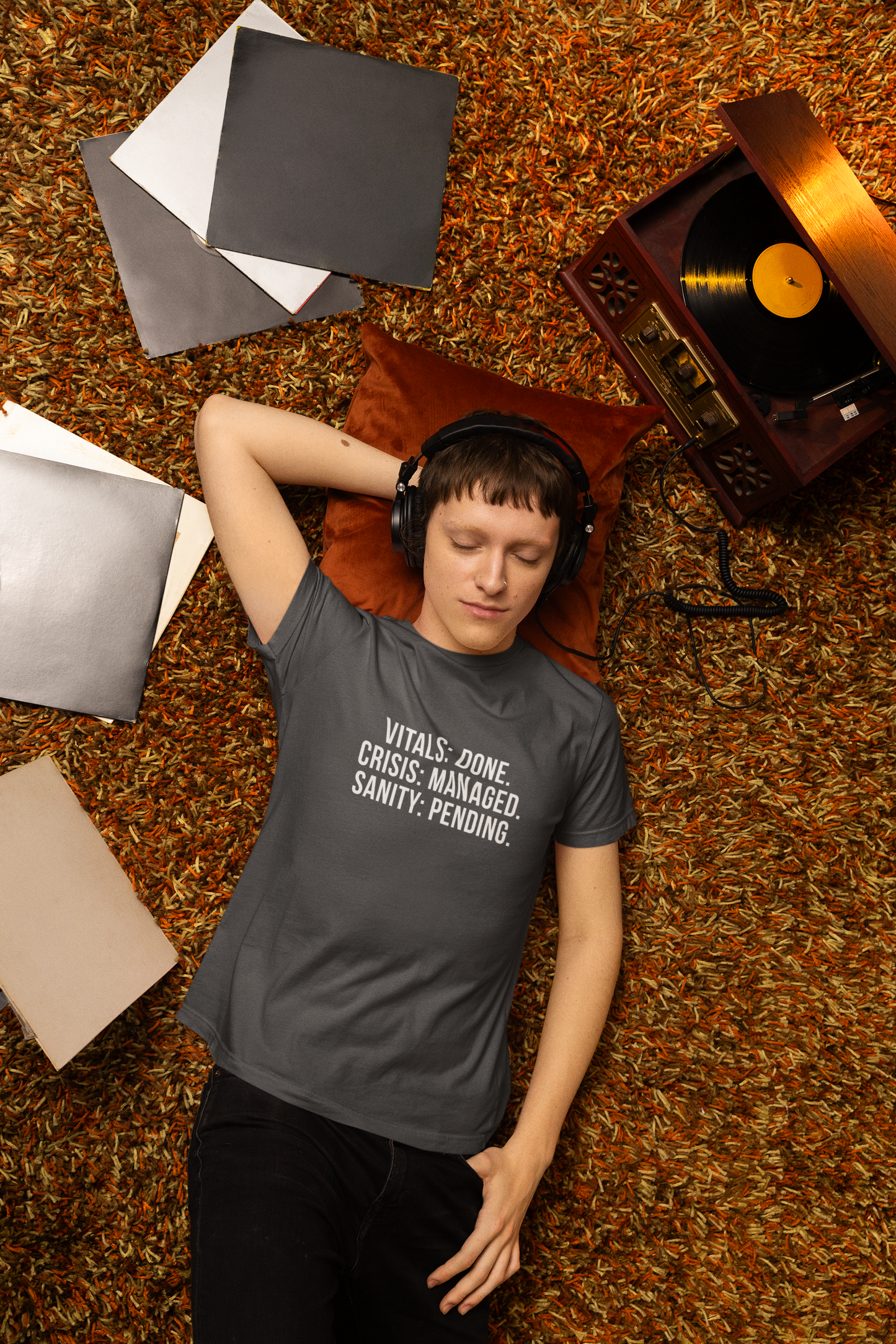 Nurse lying down on-call bed wearing the sanity pending burnout t-shirt.