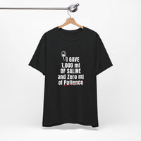 Black nurse humor shirt on hanger with bold white text: I Gave 1,000 ml of Saline and Zero ml of Patience.
