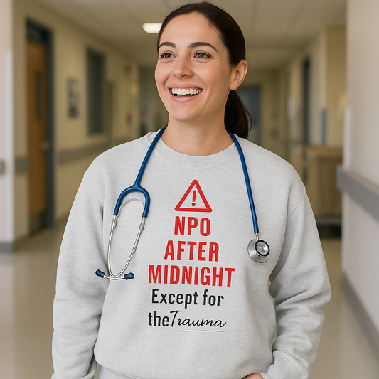 Funny nurse sweatshirt with quote “NPO After Midnight (Except for the Trauma),” worn by exhausted RN dodging chaos at 2 a.m.
