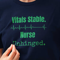 Closeup of “Vitals Stable. Nurse Unhinged.” text and ECG line on navy t-shirt, bold readable print for burned-out nurses
