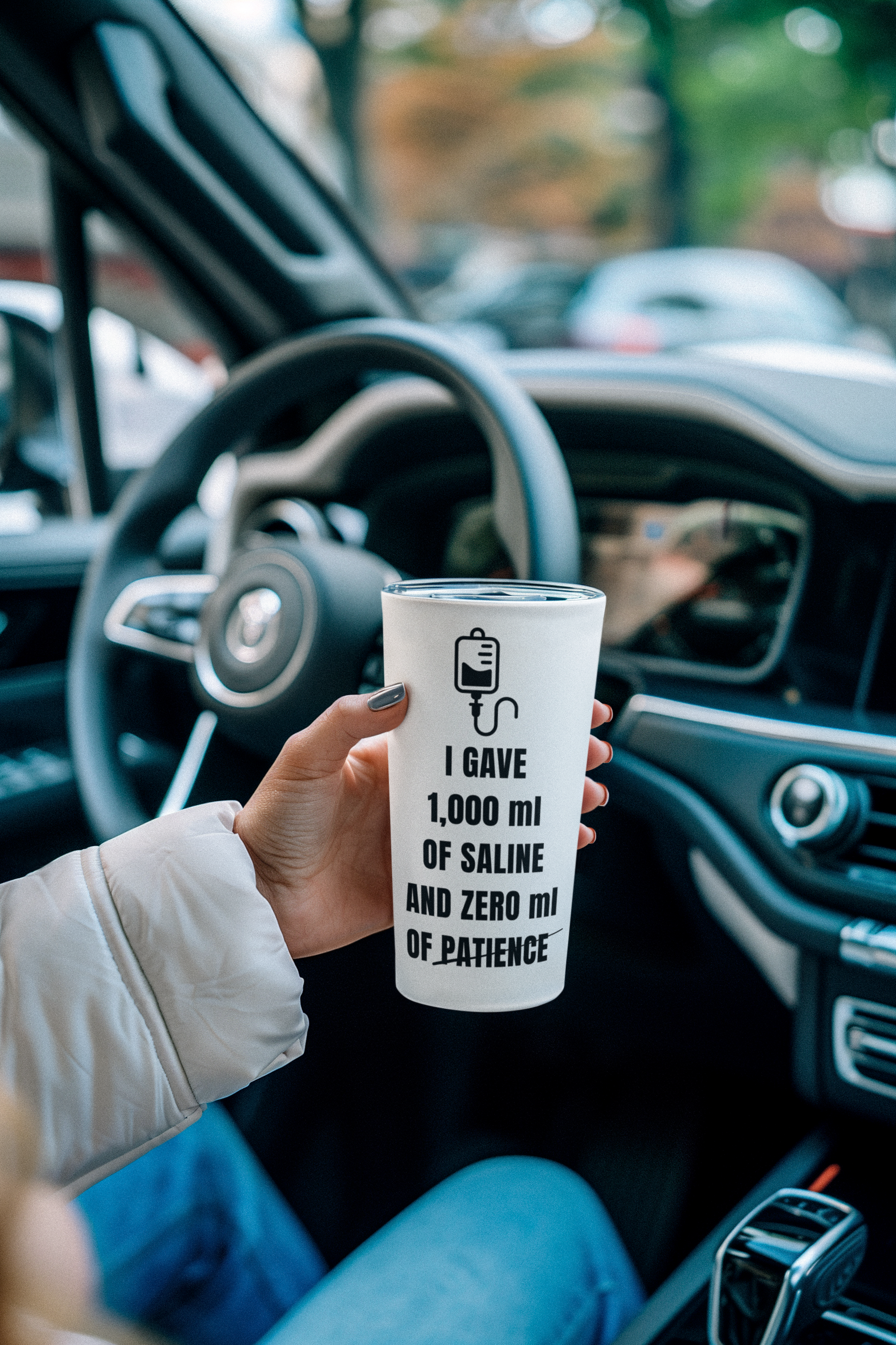 tumbler with “zero mL of patience” message in a car 