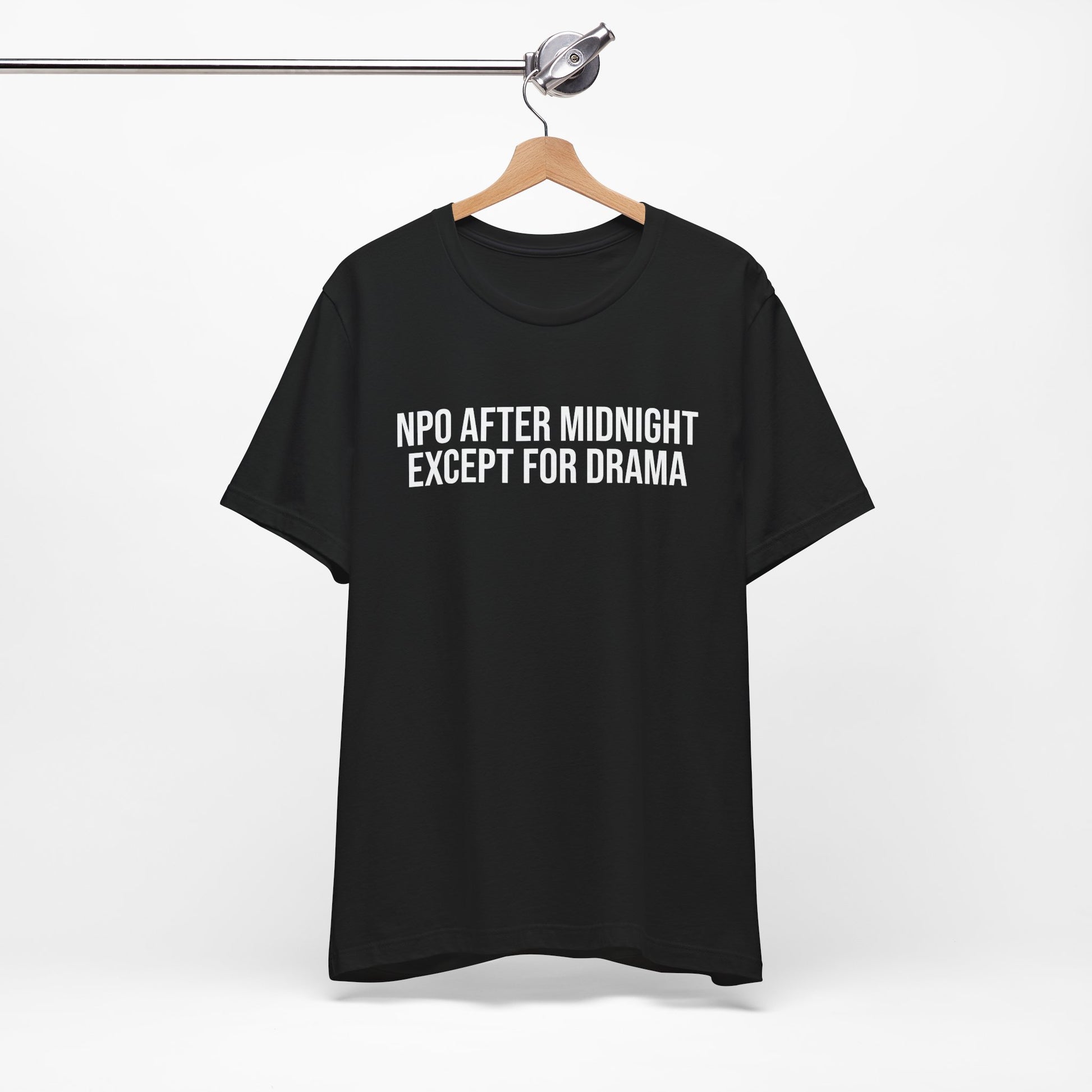 Flatlay of black unisex t-shirt with bold print: “NPO AFTER MIDNIGHT, EXCEPT FOR DRAMA.”
