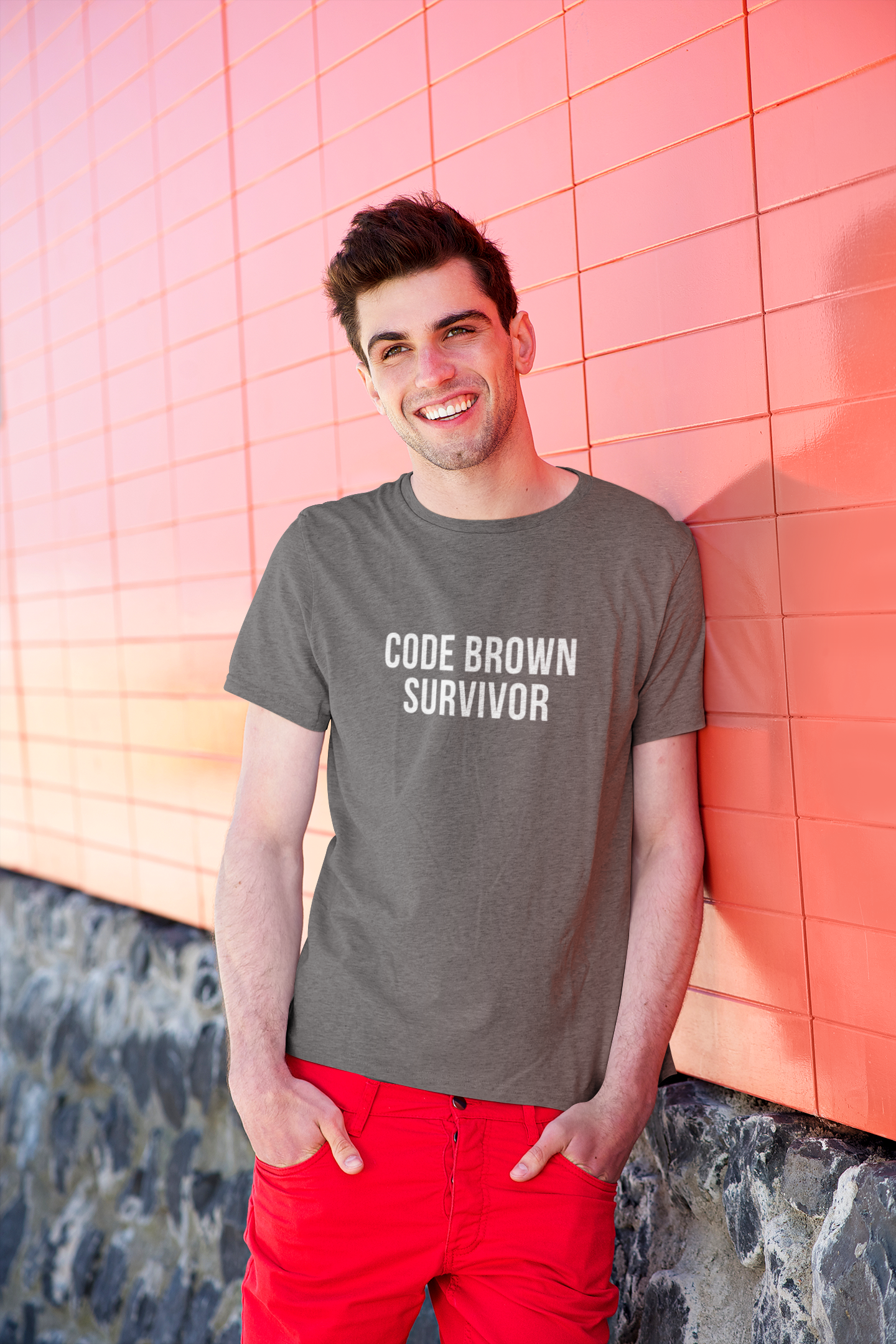 Smiling nurse outside, wearing fitted black tee with “Code Brown Survivor” design.