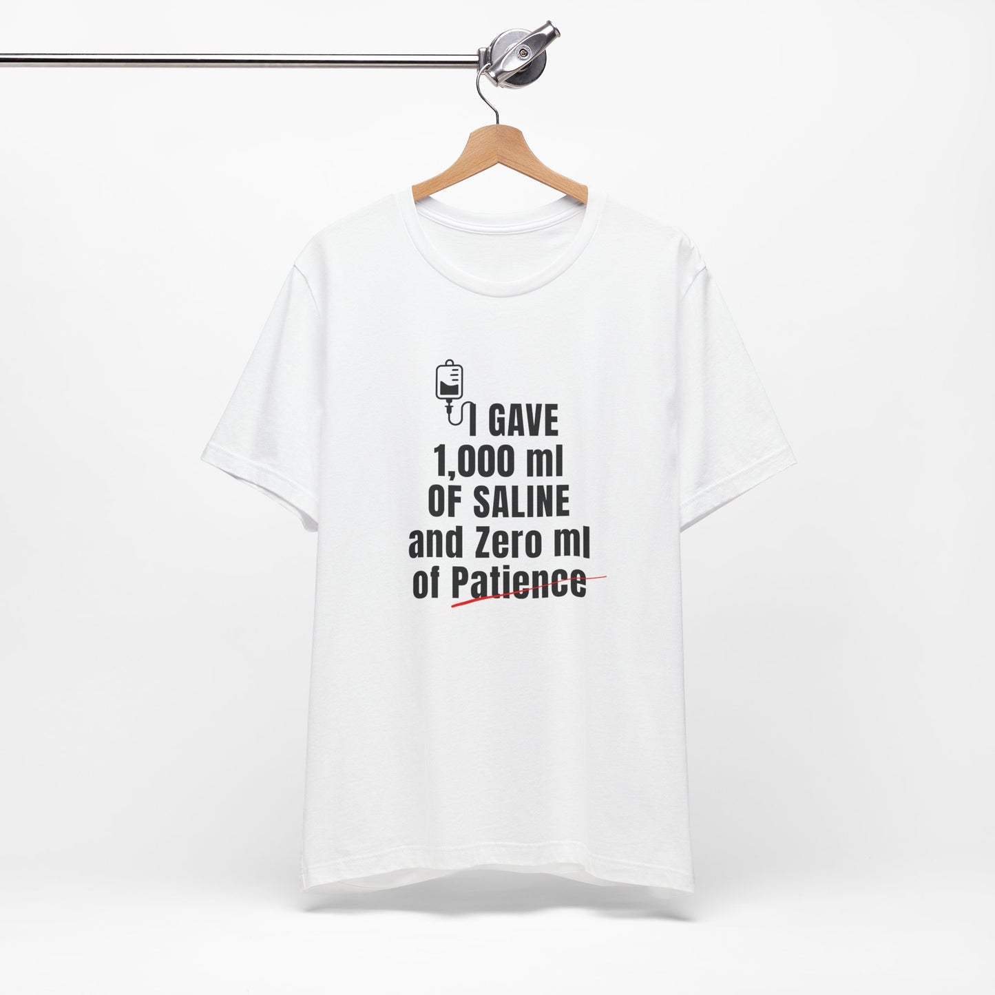 Flat lay of white shirt with bold text showing classic IV therapy burnout humor.
