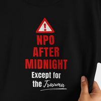 Close-up of shirt print: NPO After Midnight Except for the Trauma, warning triangle icon, bold red and white text on black fabric.
