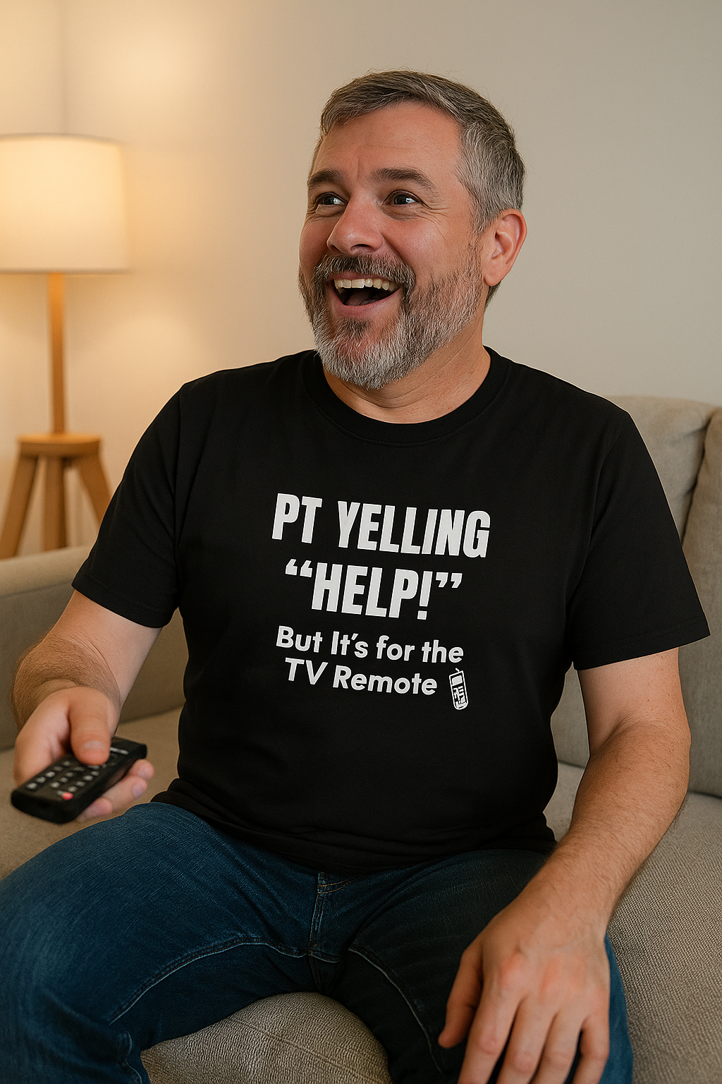 Burnout nurse sitting with arms resting on knees, wearing black “PT Yelling Help” tee.
