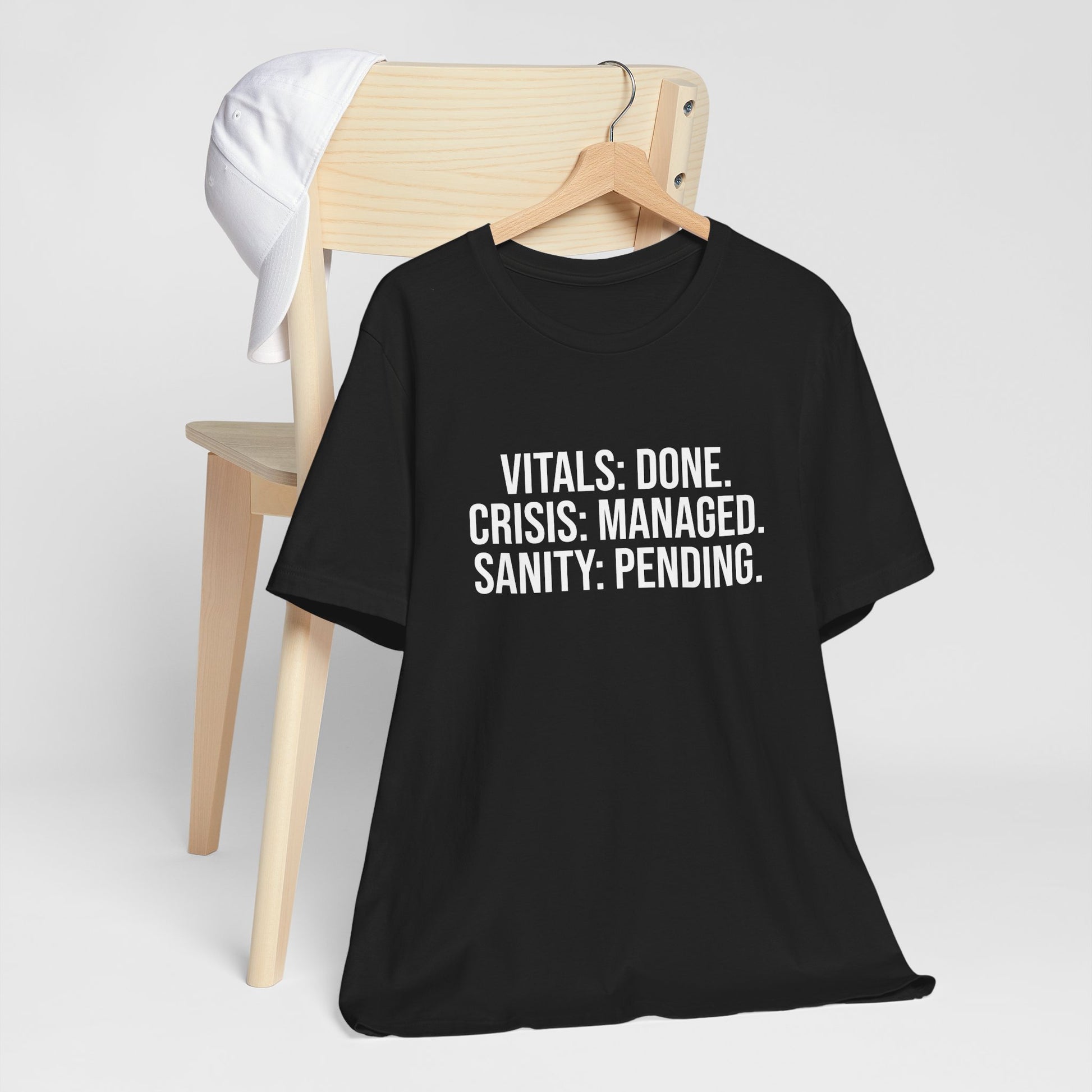 Flat lay of black t-shirt on hanger displaying the burnout nurse quote.
