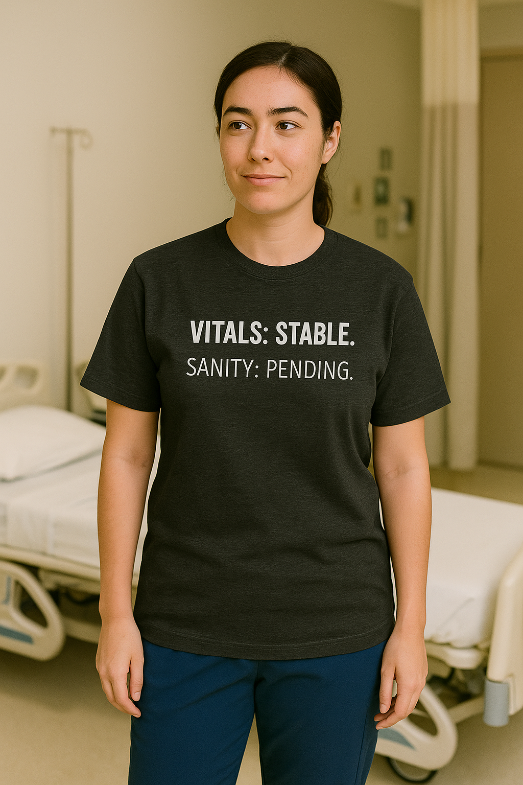 Nurse walking down hall in black “Vitals: Stable. Sanity: Pending.” crewneck tee.
